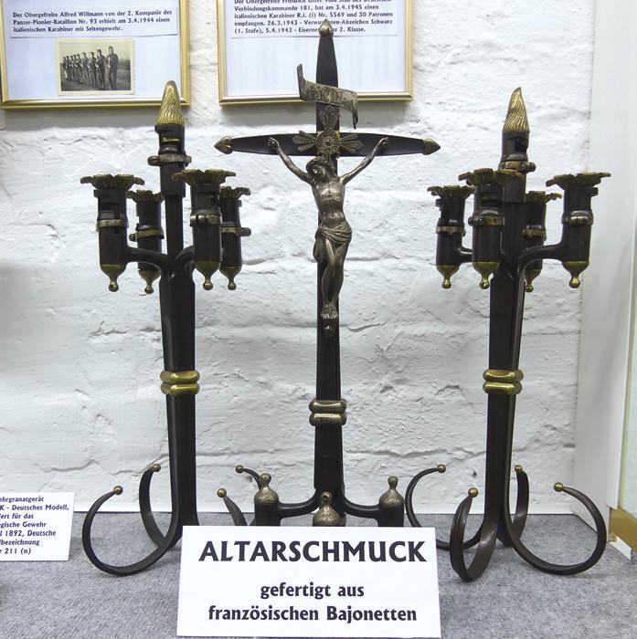 Nach dem Ersten und dem Zweiten Weltkrieg wurde viel Wehrmaterial für die zivile Nutzung umgebaut. So entstand zum Beispiel Altarschmuck aus französischen Bajonetten. Nach dem Ersten und dem Zweiten Weltkrieg wurde viel Wehrmaterial für die zivile Nutzung umgebaut. So entstand zum Beispiel Altarschmuck aus französischen Bajonetten.