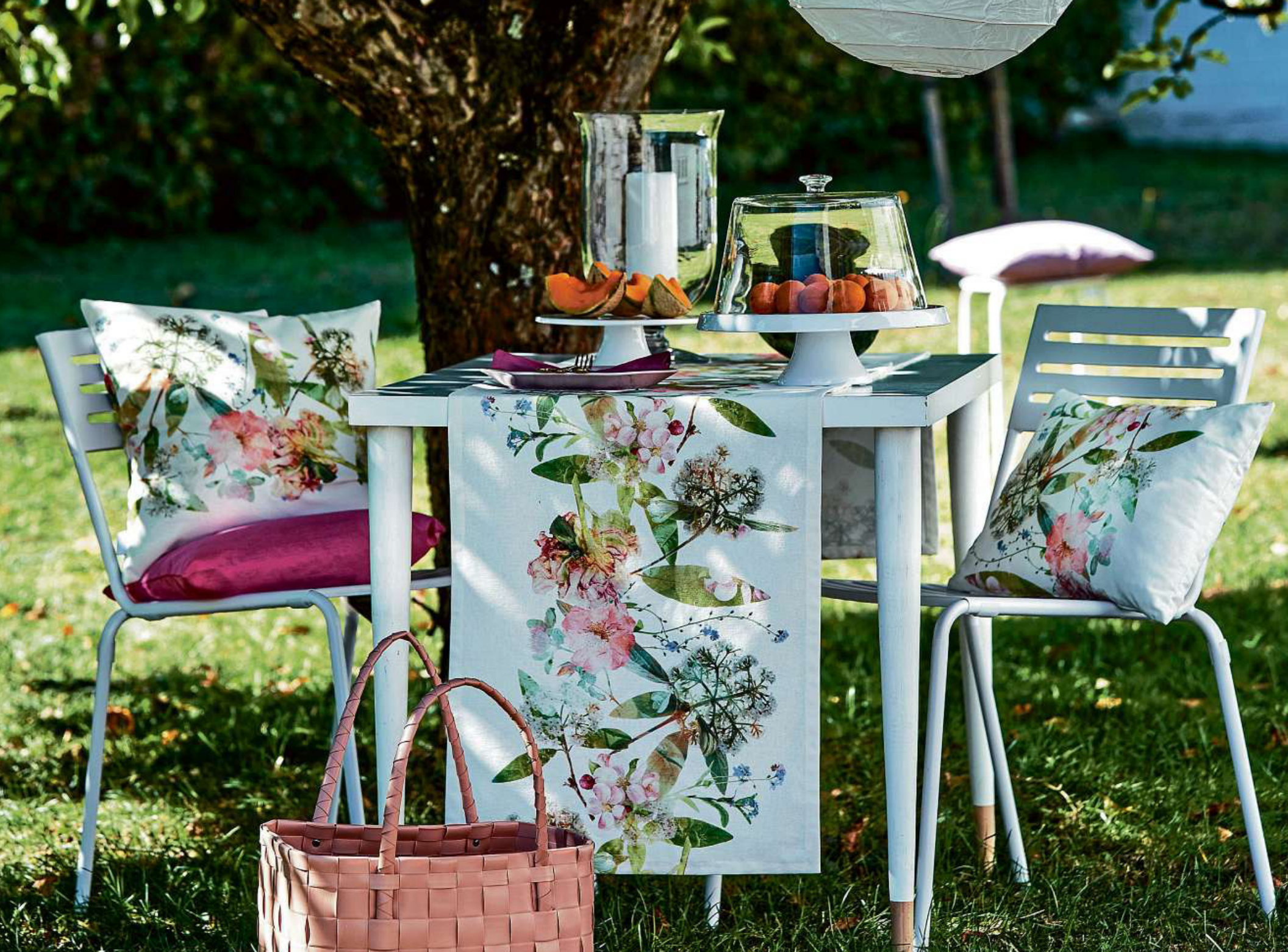 Nehmen Sie Platz und lassen Sie sich verzaubern: Florales in weichen Pastelltönen ziert Kissen und die dazu passende Tischdecke. FOTO: APELT