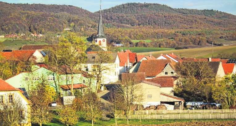 Die Ortsansicht von Happertshausen aus Richtung Aidhausen mit den Haßbergen im Hintergrund. Die Ortsansicht von Happertshausen aus Richtung Aidhausen mit den Haßbergen im Hintergrund.