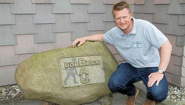 Den Findling hat Malte Dobbrick auf einer Baustelle ausgegraben. Von einem Steinmetz ließ er das Firmenlogo einmeißeln. FOTO: KIB Den Findling hat Malte Dobbrick auf einer Baustelle ausgegraben. Von einem Steinmetz ließ er das Firmenlogo einmeißeln. FOTO: KIB