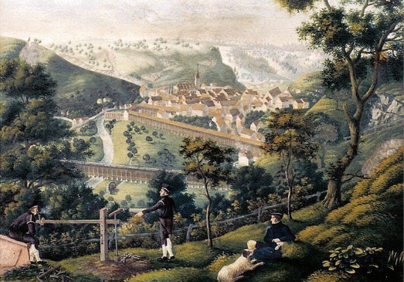 Blick auf die Salinenstadt Sulz am Neckar um 1817 von der Glatter Steige aus gesehen und gemalt vom Geologen, Bergrat und Salinisten Friedrich von Alberti, der sich selbst mit Hund im Vordergrund verewigt hat. Eindrucksvoll rückte Alberti die damals mehr als 1200 Meter langen Gradierhäuser sowie die Muschelkalk-Aufschlüsse am Talhang in den Fokus. Alberti, der einstige Leiter der Sulzer Saline, ist vor allem als Namensgeber der erdgeschichtlichen Trias-Periode bekannt. Repro: Wiedemann